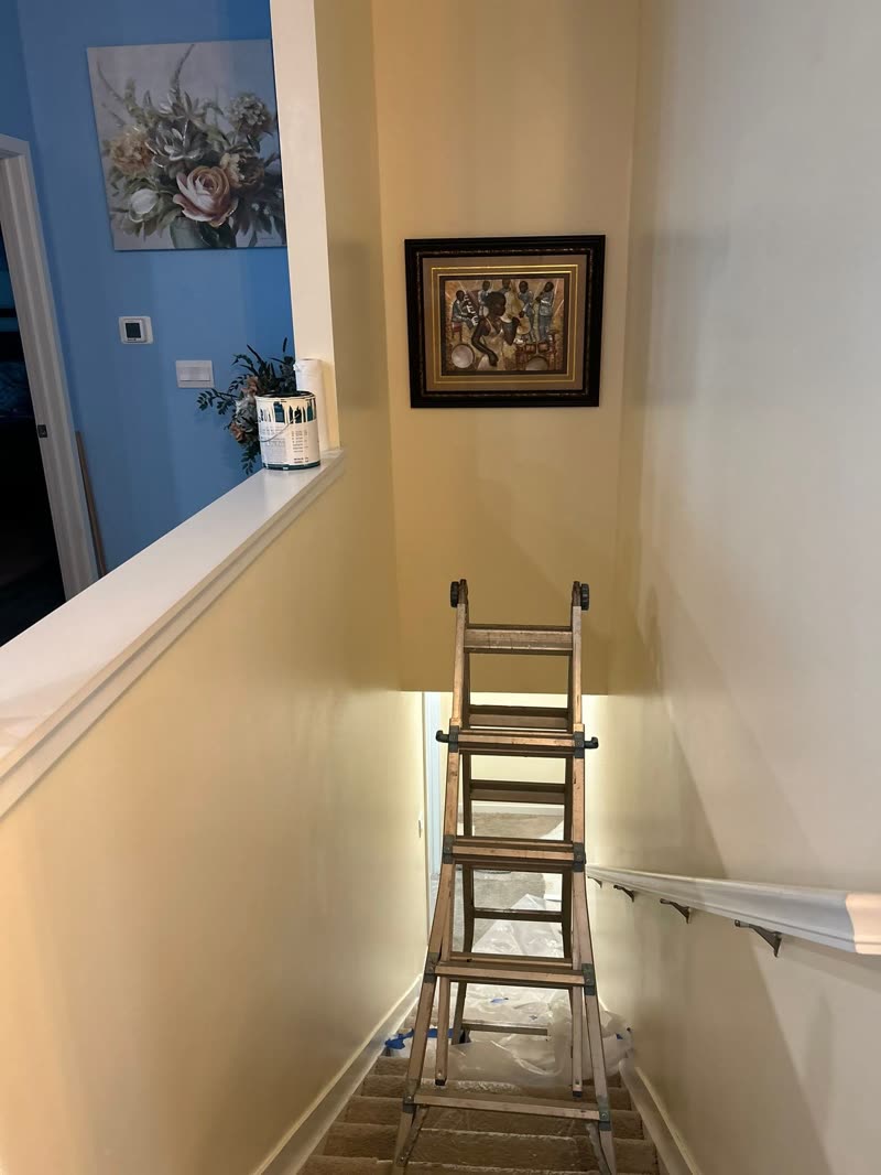 Stairwell after — smooth warm-cream painted walls